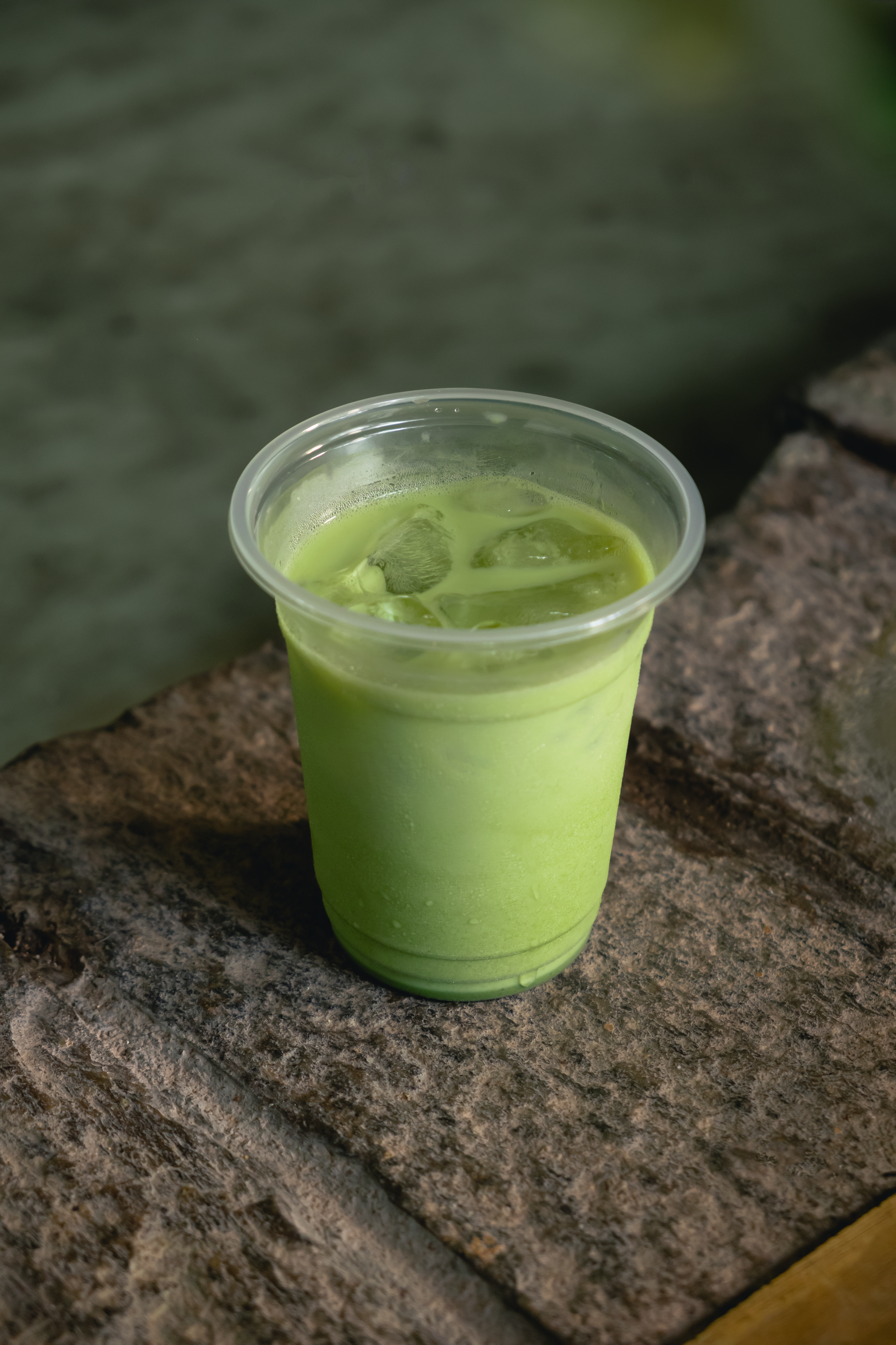 Iced matcha latte on stone